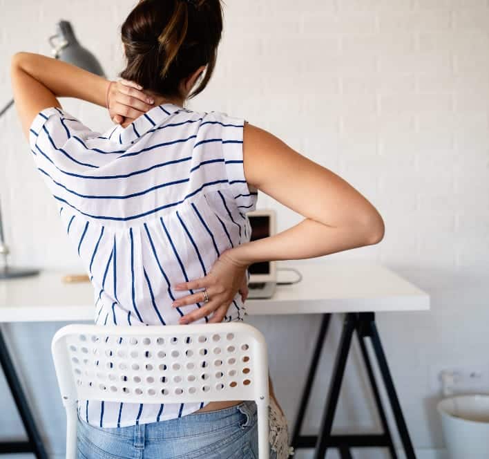 https://www.njspineandortho.com/wp-content/uploads/2021/04/Woman-having-back-pain-while-working-in-office.jpg